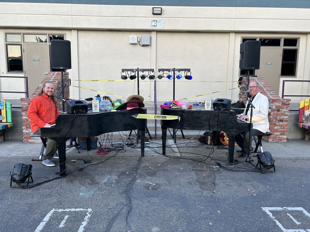 Full outdoor daytime dueling piano rig with PA speakers and lighting tree